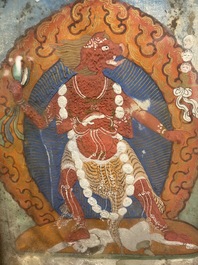A Tibetan thangka in inlaid gilt brass frame, 19th C.